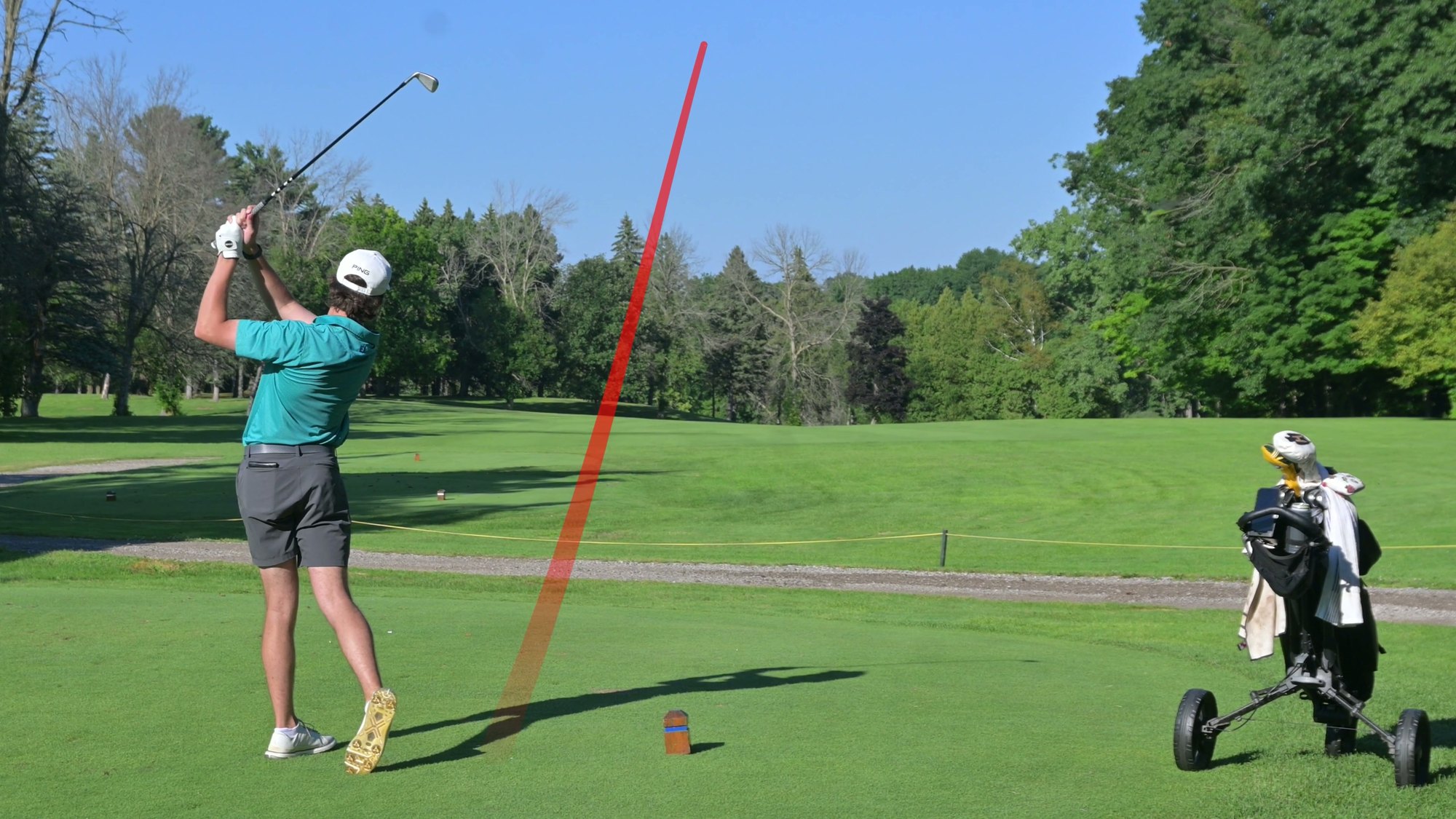 Nic Hughes follow-through with the ball flight traced down the fairway