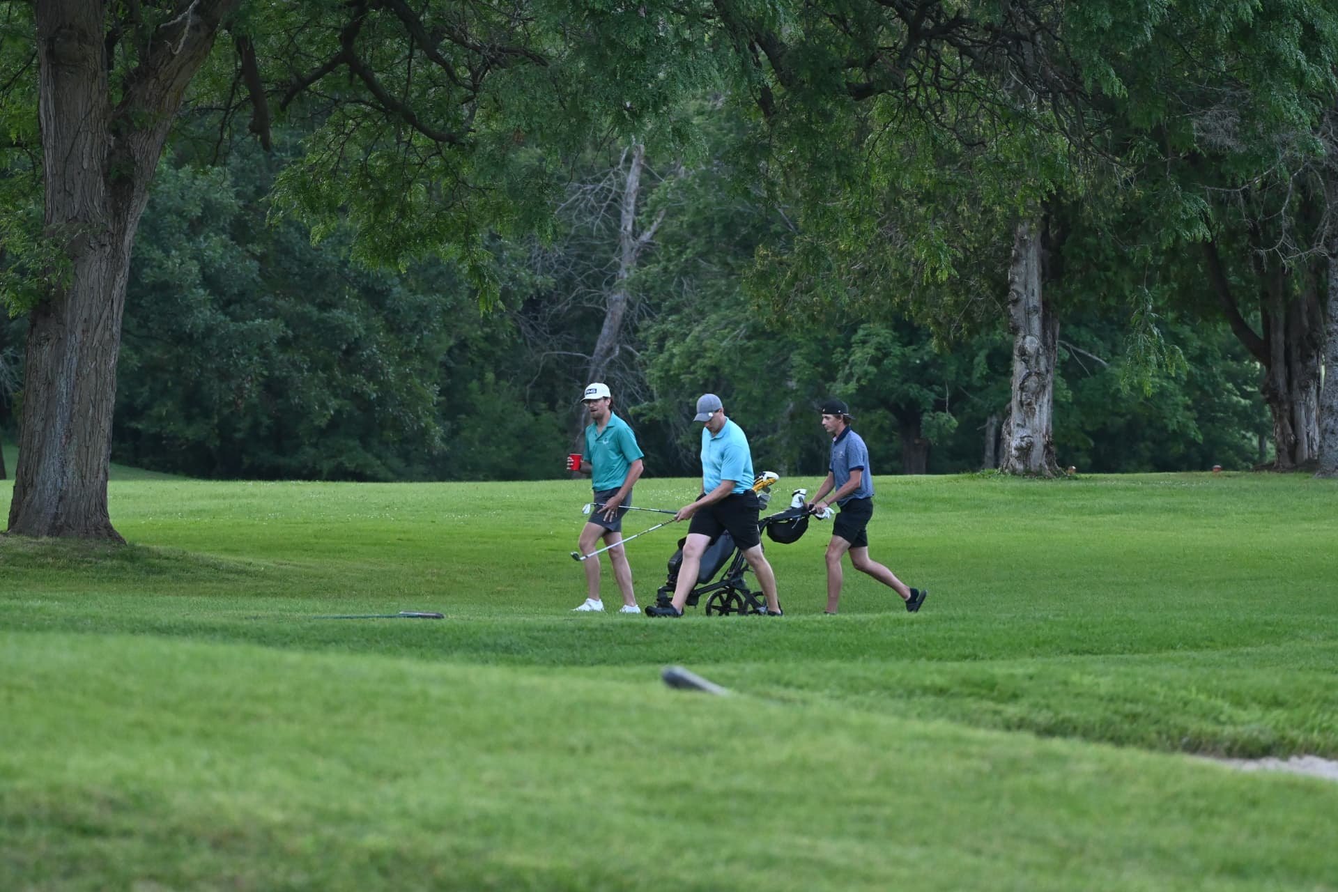 Nic Hughes walking the fairway with the final group