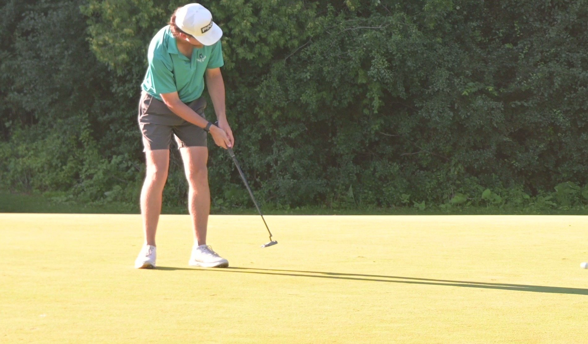 Nic Hughes rolling a putt on the green at Brown County Golf Course