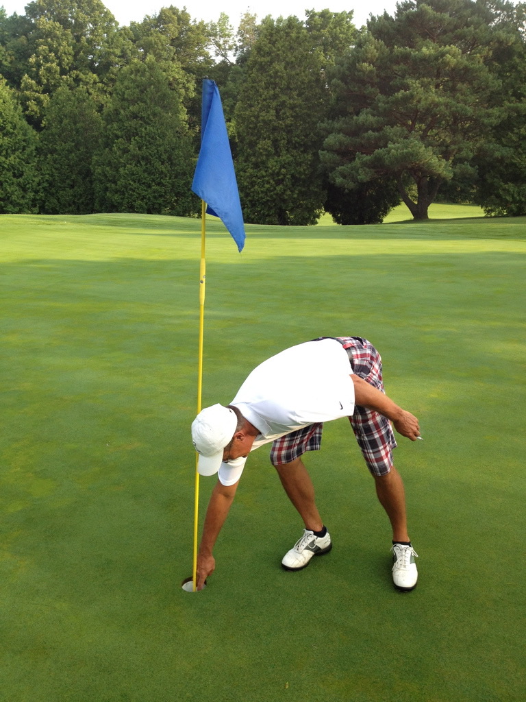 Jim Williquette pulling his ball from the cup